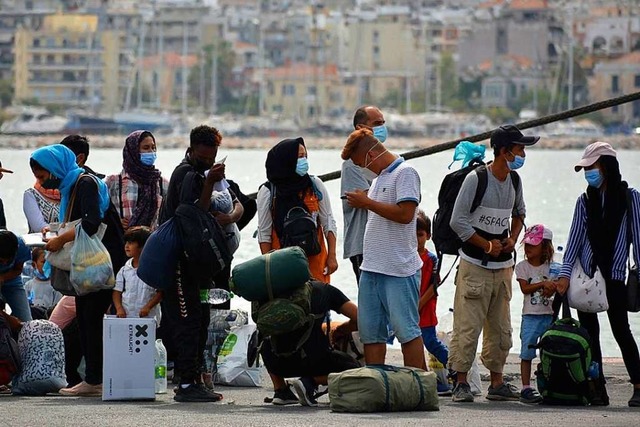 Geflchtete warten auf der griechische...os auf die berfahrt auf das Festland.  | Foto: Panagiotis Balaskas (dpa)
