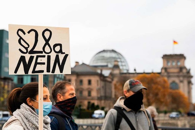 Whrend im Reichstagsgebude (hinten) ...Infektionsschutzgesetzes demonstriert.  | Foto: Christoph Soeder (dpa)