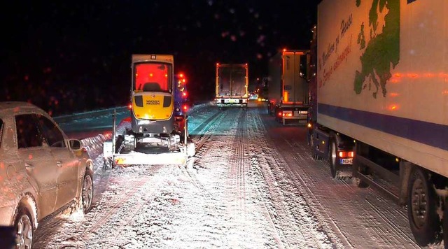 Lkws und Autos stehen auf der Autobahn...render Klte in ihren Autos ausharren.  | Foto: Festim Beqiri (dpa)