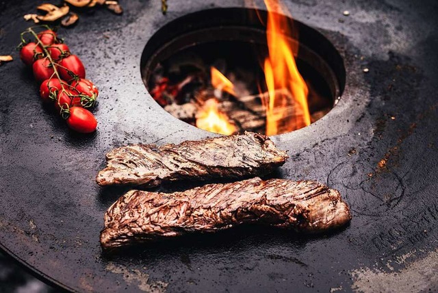 Die Feuerplatte &#8211;  hier mit Risp...ibt es als Aufsatz fr den Kugelgrill.  | Foto: Oliver Quaas (dpa)