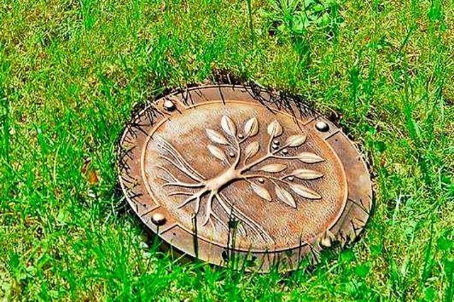 So sieht ein Urnenbaumgrab in einer Wiese aus.  | Foto: Weiher GmbH