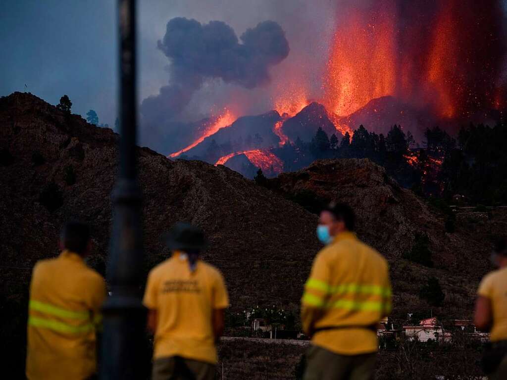 Feuerwehrleute beobachten den Ausbruch.