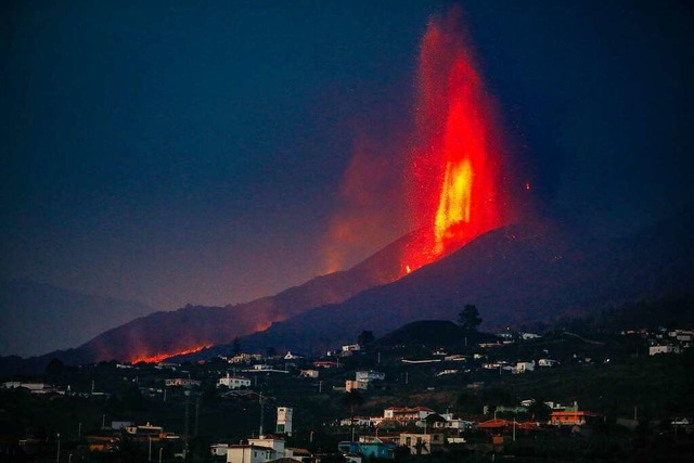 Wie Feuerlanzen aus dem Vulkan Cumbre ...ar Ahues aus ihrer Wohnung beobachtet.  | Foto: Kike Rincn (dpa)