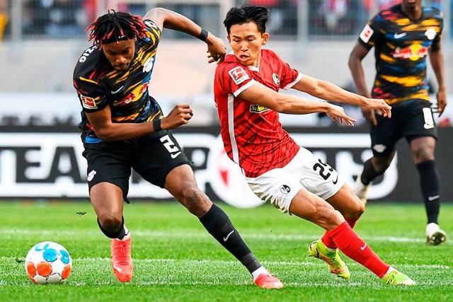 Wooyeong Jeong gegen Leipzigs Simakan.  | Foto: THOMAS KIENZLE (AFP)