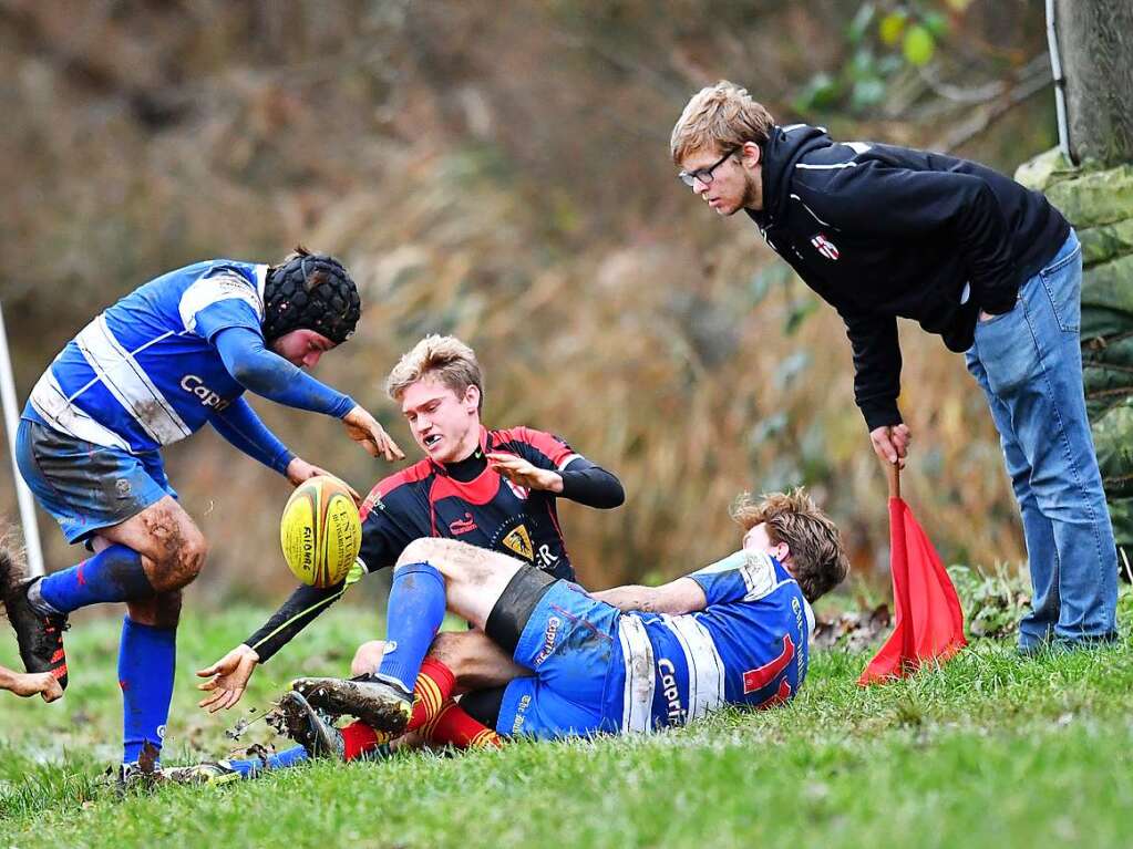 Kampf, Matsch und mehr: Impressionen vom Drittliga-Rugbyspiel zwischen Freiburg (in schwarz-rot) und Heidelberg (blau-wei).