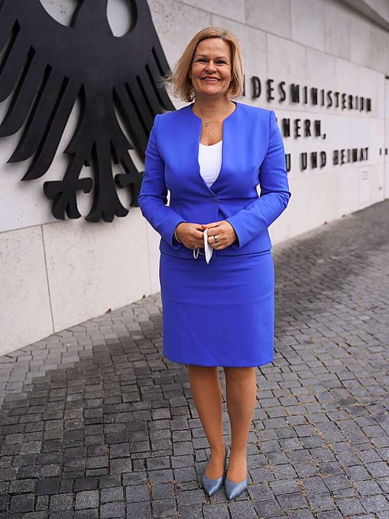 Nancy Faeser (SPD), Bundesinnenministerin, steht am Eingang des Bundesinnenministeriums.