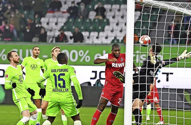 Anthony Modeste (in Rot) trifft hier zum 1:1 gegen staunende Wolfsburger.  | Foto: Swen Pfrtner (dpa)