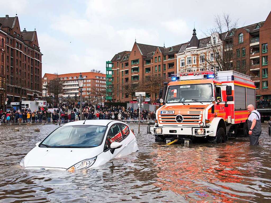 Ein Auto wird auf dem Fischmarkt whrend einer Sturmflut von der Feuerwehr aus dem Wasser der Elbe gezogen.