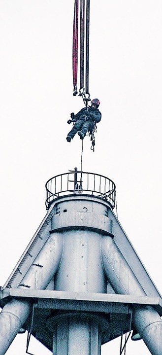 Ein Mitarbeiter wird per Seil in den Parabolpiegel hinuntergelassen.  | Foto: Sandra Decoux-Kone