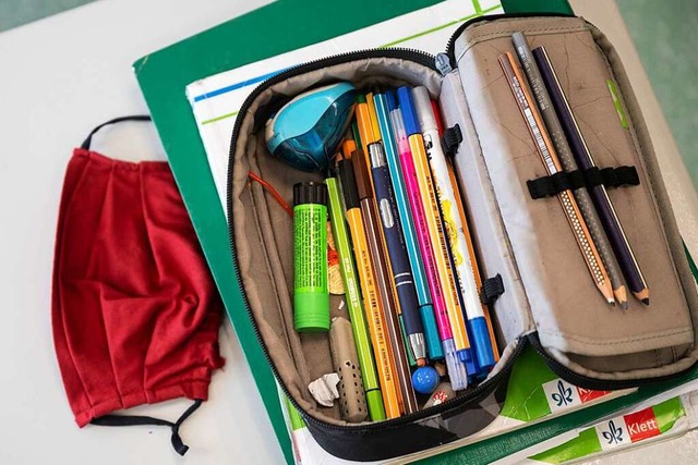 Maske neben Mäppchen: In Schulen muss Mund-Nasenschutz getragen werden. | Foto: Marijan Murat (dpa) Maske neben Mäppchen: In Schulen muss Mund-Nasenschutz getragen werden. | Foto: Marijan Murat (dpa)