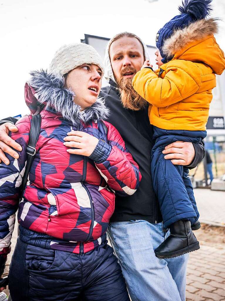 Die Ukrainerin Oksana  geht mit ihrem Mann Aiwaras und Sohn Leo nach ihrem Grenzbertritt von Schehyni in der Ukraine nach Medyka in Polen.