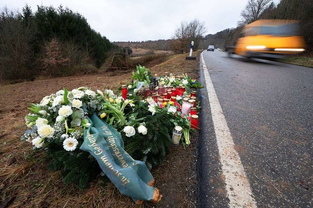 Blumen und Kerzen stehen an dem Tatort... Verkehrskontrolle ers chossen wurden.  | Foto: Sebastian Gollnow (dpa)
