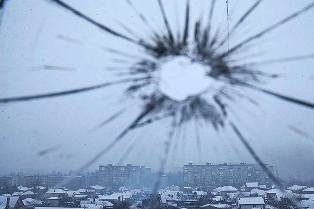 Blick aus einem durch Granatenbeschuss...n von russischen Truppen eingekesselt.  | Foto: Evgeniy Maloletka (dpa)