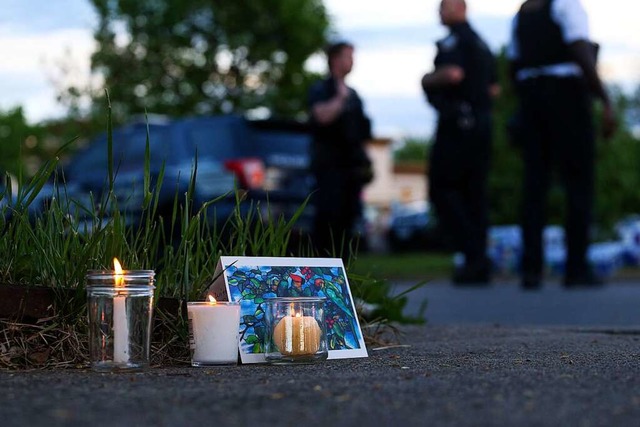 Kerzen und ein Bild stehen in der Nhe...rffnet und zehn Menschen gettet hat.  | Foto: Joshua Bessex (dpa)
