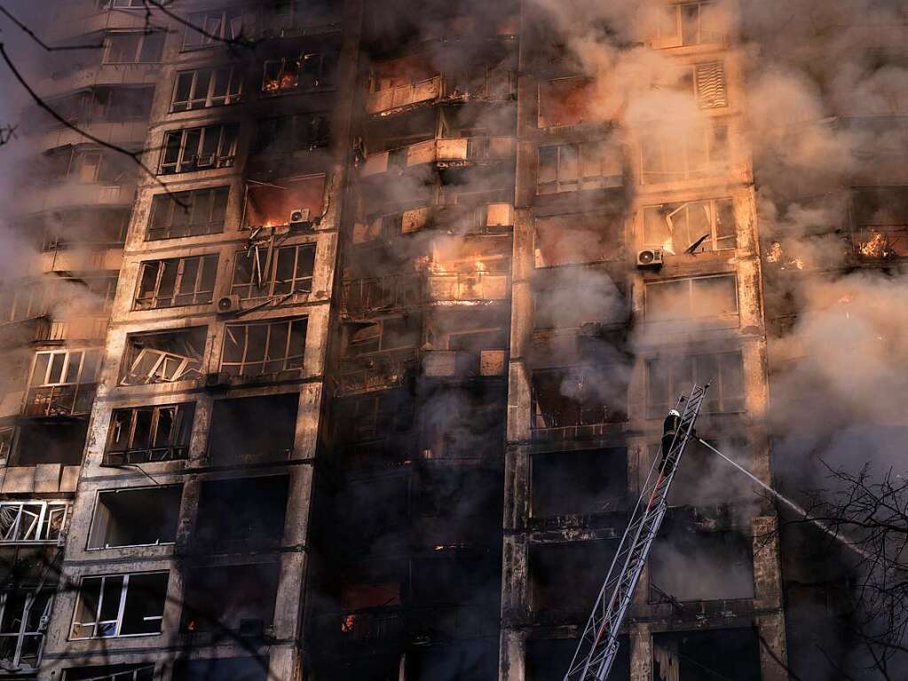 Ukrainische Feuerwehrleute arbeiten an einem Wohnhaus nach einem Bombenanschlag.