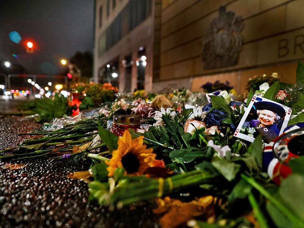 Blumen und Kerzen liegen als Zeichen der Trauer nach dem Tod der britischen Queen Elizabeth II. vor der Britischen Botschaft.