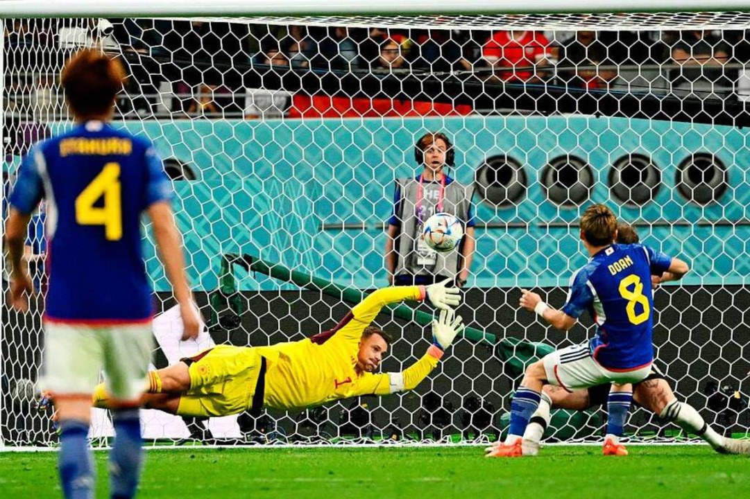 Japans Mittelfeldspieler Ritsu Doan sc...er Neuer kann den Ball nicht abwehren.  | Foto: INA FASSBENDER (AFP)