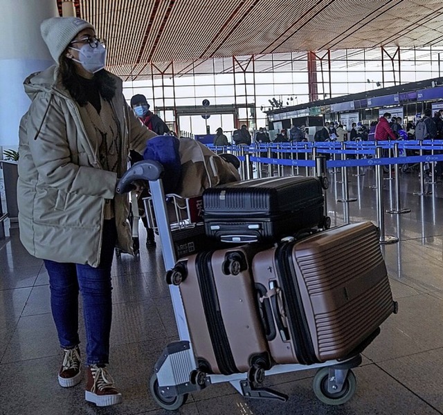 Reisende auf dem Flughafen Peking  | Foto: Andy Wong (dpa)