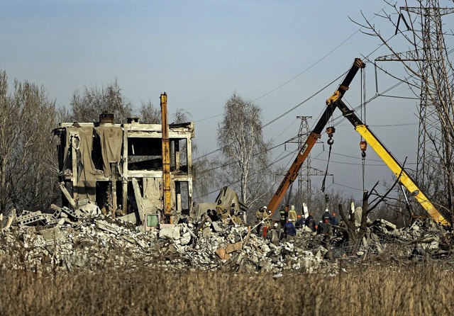 Arbeiter rumen Trmmer nach einem Rak...ussland besetzten Stadt Makijiwka weg.  | Foto: Uncredited (dpa)