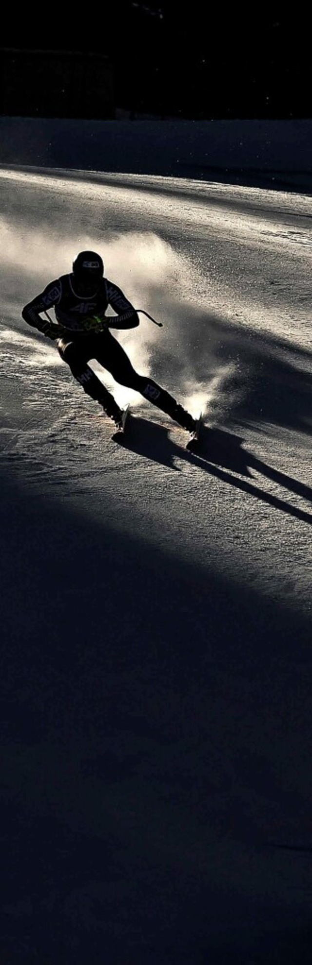 Ein Skirennfahrer bei der WM in den fr...chen Alpen, aufgenommen im Gegenlicht.  | Foto: JEFF PACHOUD (AFP)