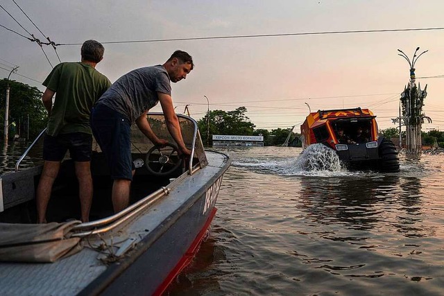 Rettungskrfte evakuieren Menschen in ... berschwemmten Stadtteil von Cherson.  | Foto: Evgeniy Maloletka (dpa)