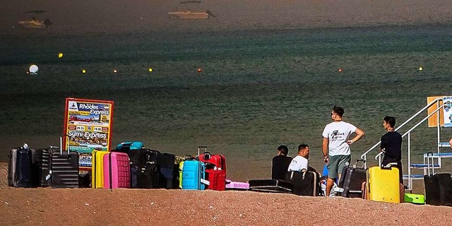 Menschen warten auf der griechischen I...nden in Sicherheit gebracht zu werden.  | Foto: Argiris Mantikos (dpa)