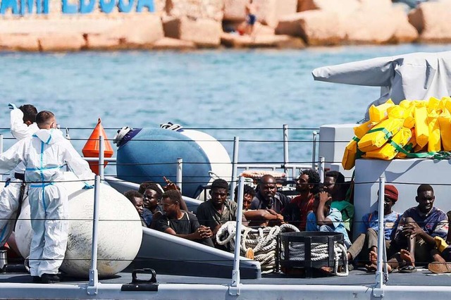 Gerettete Migranten werden mit einem B...i in den Hafen von Lampedusa gebracht.  | Foto: Cecilia Fabiano (dpa)