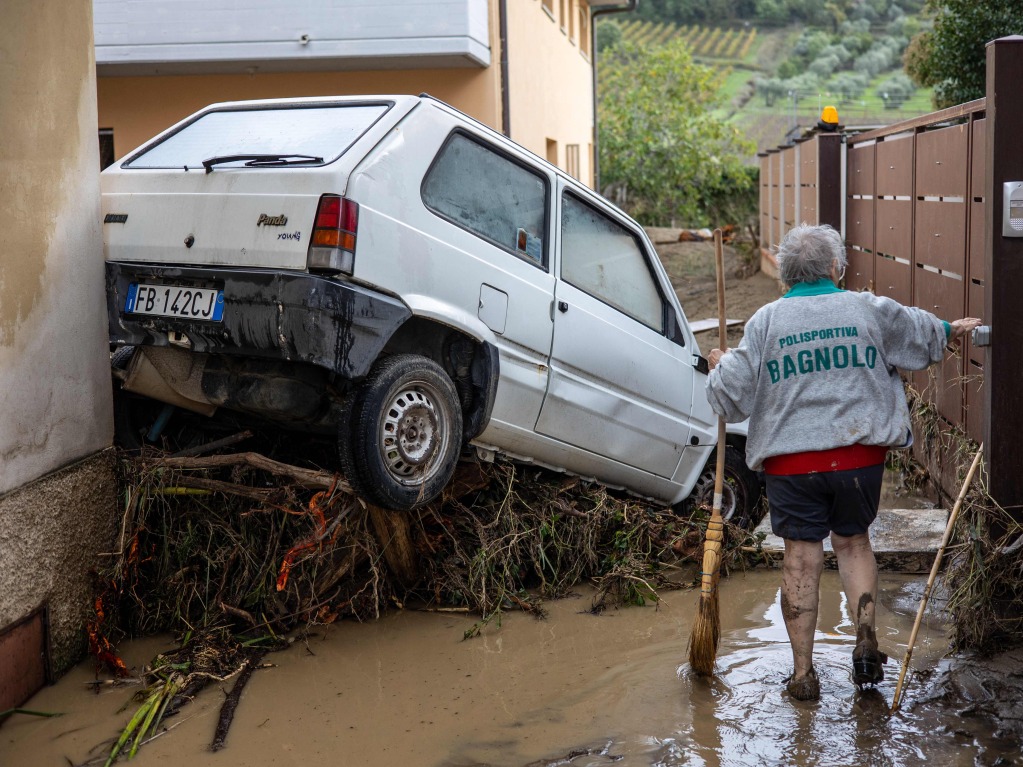 Italien, Montemurlo in der Toskana: Eine Frau versucht den Schlamm wegzuputzen.