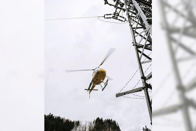 Helikopter fliegt Stromleitungen ab