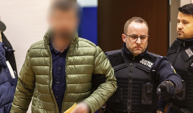 Ein Justizbeamter fhrt den Angeklagte...richtssaal des Landgerichts Waldshut.   | Foto: Philipp von Ditfurth/dpa
