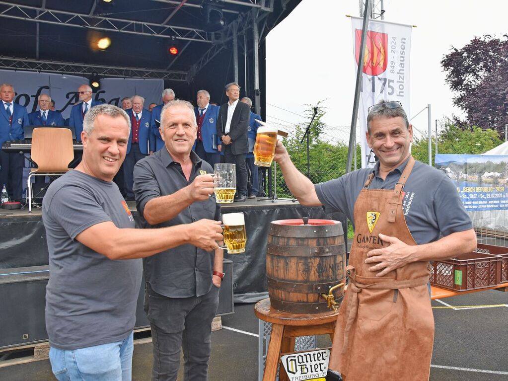 Holzhausens Ortsvorsteher Rolf Lorenz (rechts) mit Assistenten beim Fassanstich am Samstag.