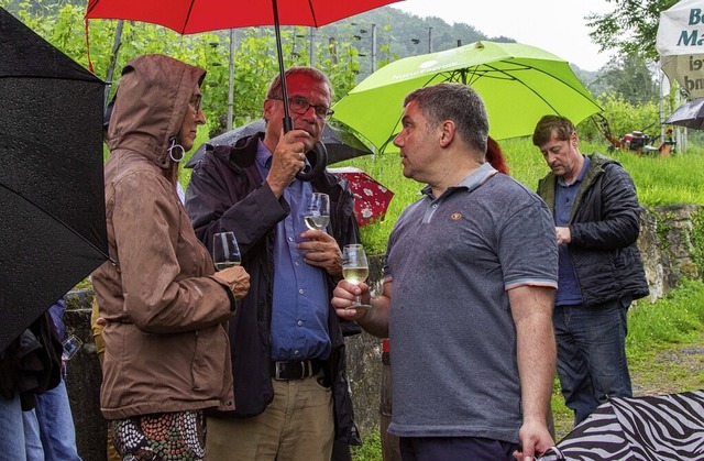 Weinverkostung unterm Regenschirm mit OB Eberhardt (Mitte).  | Foto: Frank Brauer