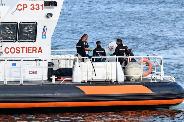 Beamte der italienischen Kstenwache b...fes Bayesian, in einem Sack an Land.  | Foto: Salvatore Cavalli (dpa)