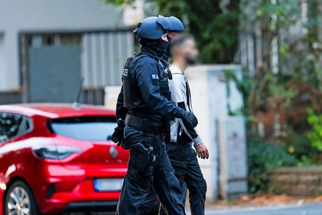 Die Polizei fhrt den Tatverdchtigen ab.  | Foto: Christoph Reichwein (dpa)