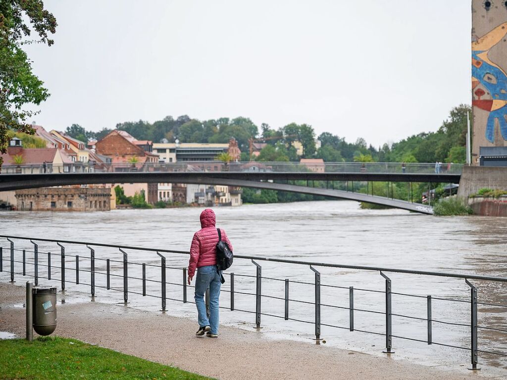 Grlitz: Eine Passantin luft an der Uferpromenade an der Uferstrae und beobachtet das Hochwasser der Neie.