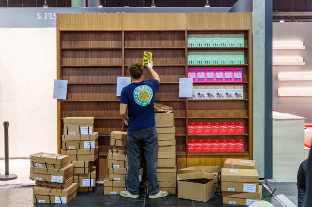 Ein Mann r&auml;umt am Stand von S. Fi...sstellungsregale mit B&uuml;chern ein.  | Foto: Andreas Arnold/dpa