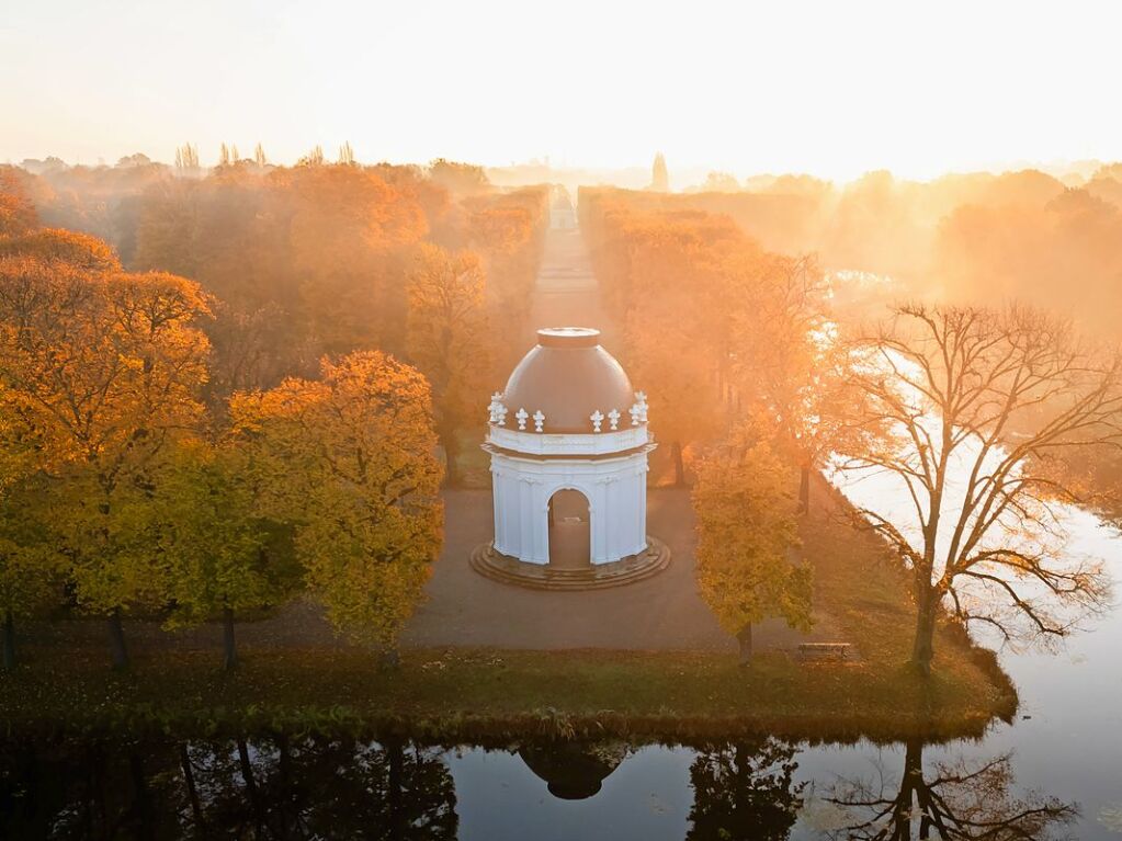 Niedersachsen, Hannover: Die aufgehende Sonne taucht Nebelschwaden ber einen der Eckpavillons des franzsischen Architekten Remy de la Fosse in den Herrenhuser Grten in goldenes Licht.