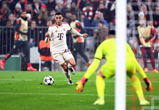 Die Bayern, hier Jamal Musiala (l), ra...n Benfica-Schlussmann Anatolij Trubin.  | Foto: Sven Hoppe/dpa