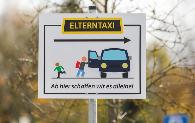 Am Parkplatz eines Schulgelndes in Ri...en steht ein Elterntaxi-Hinweisschild.  | Foto: Thomas Warnack (dpa) 