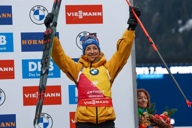 Franziska Preu&szlig; feiert auf dem Podium ihren dritten Platz.  | Foto: Alessandro Trovati/AP/dpa