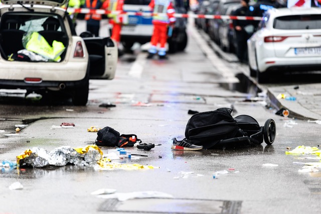 Kleidung und ein Kinderwagen liegen nach dem Anschlag auf der Stra&szlig;e.  | Foto: Matthias Balk/dpa