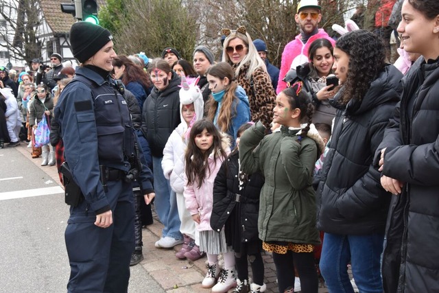 Eine Polizistin beantwortet beim Fasne...ngen  Fragen von Besuchern des Umzugs.  | Foto: Andrea Steinhart