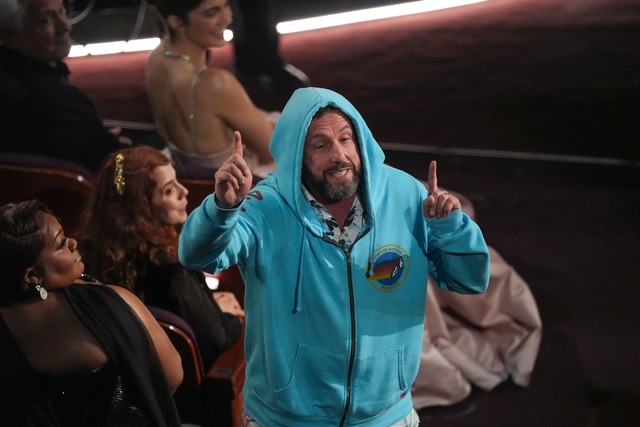 Adam Sandler sa&szlig; in Sweatshirt-Jacke und Shorts im Publikum.  | Foto: Chris Pizzello/Invision/AP/dpa