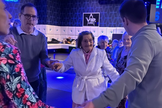 Mathilde Bouhee tanzt mit Betreuern und anderen Heimbewohnern in der Disco.  | Foto: Rachel Sommer/dpa